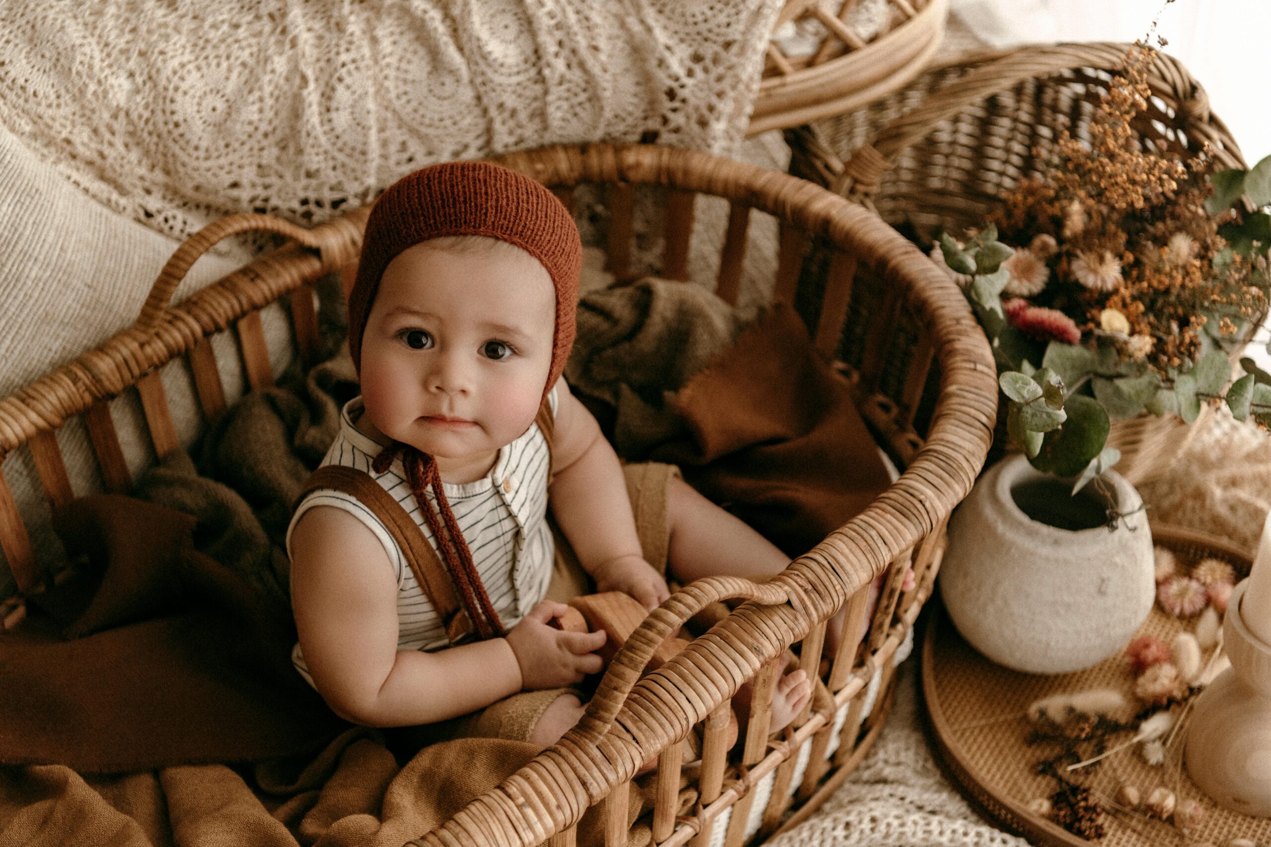 A Baby Sitting in a Basket with Autumnal Decorations // Healthier Baby Today