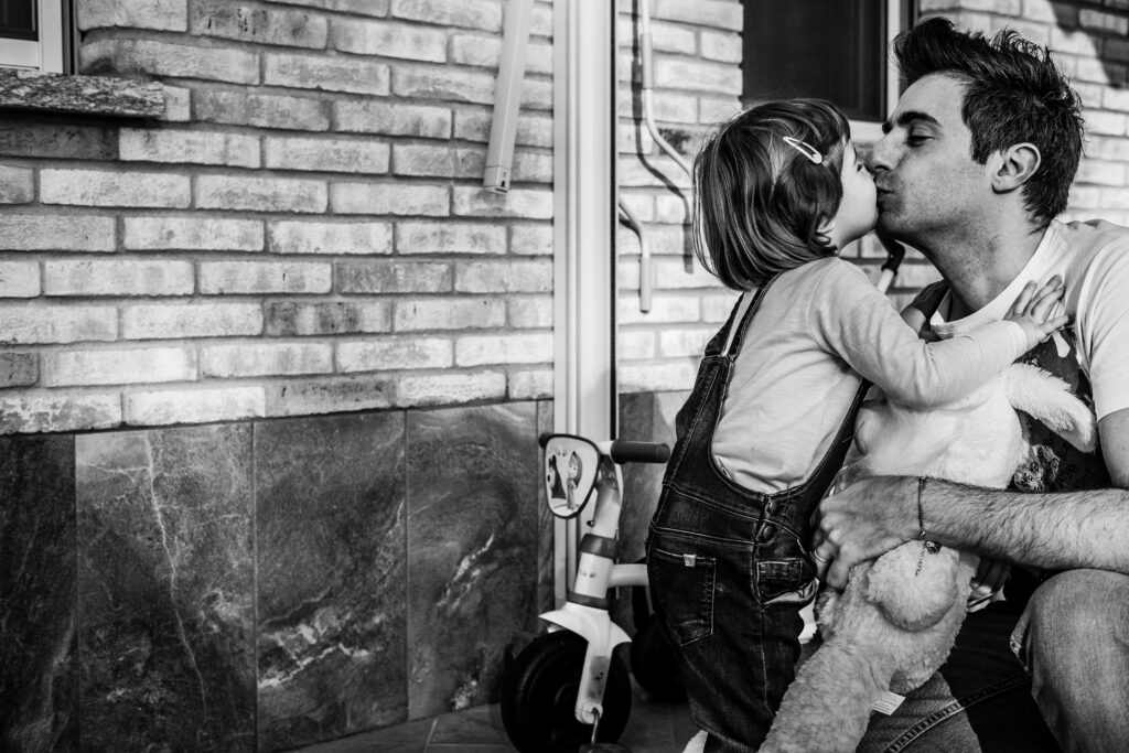 Monochrome Photo of a Father Kissing His Daughter // Healthier Baby Today