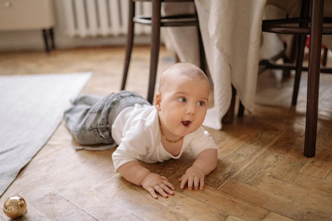 A Baby Crawling On Wooden Floor // Healthier Baby Today
