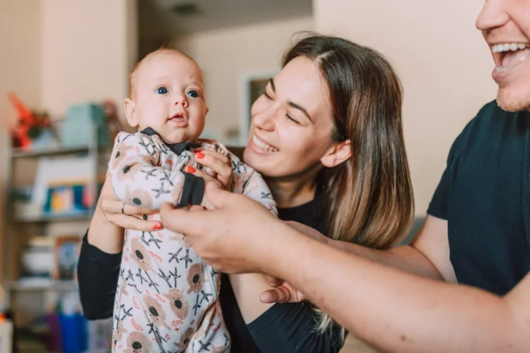 Baby Onesie, A Mother Smiling while Carrying Her Baby // Healthier Baby Today