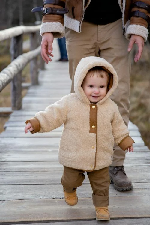 baby walking shoes, Child in Brown Jacket and Brown Pants Walking on Wooden Bridge // Healthier Baby Today