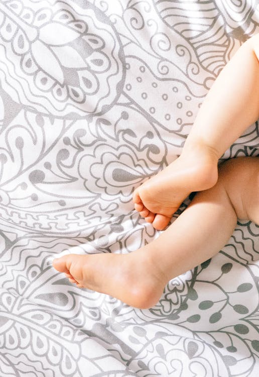 Feet of a Baby on a Bed // Healthier Baby Today
