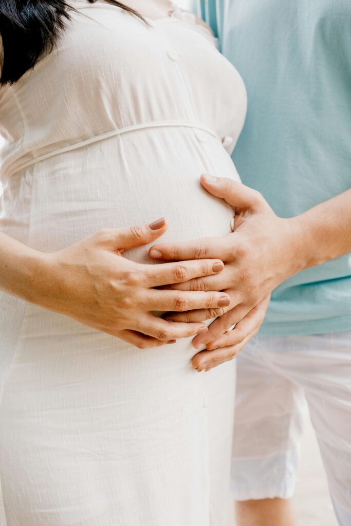 Photo of Hands Touching Baby Bump // Healthier Baby Today