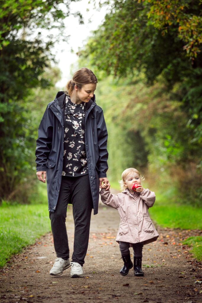 Woman Walking With Child on Pathway // Healthier Baby Today
