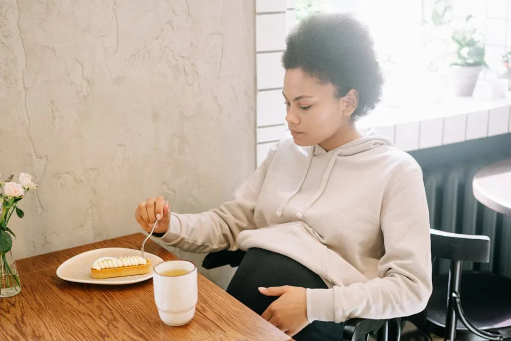 A Pregnant Woman Eating a Pie on a Ceramic Plate // Healthier Baby Today