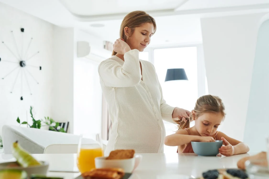 Pregnancy Meal Plan, A Woman Fixing the Hair of a Young Girl // Healthier Baby Today
