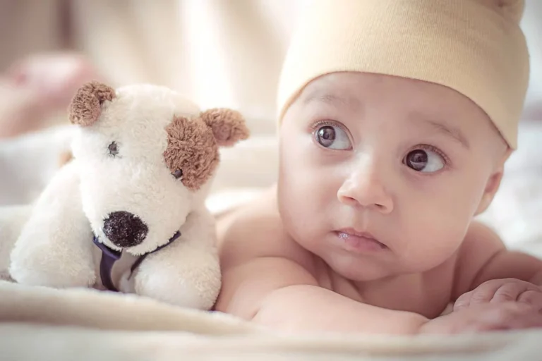 Baby Lying Near Dog Plush Toy // Healthier Baby Today