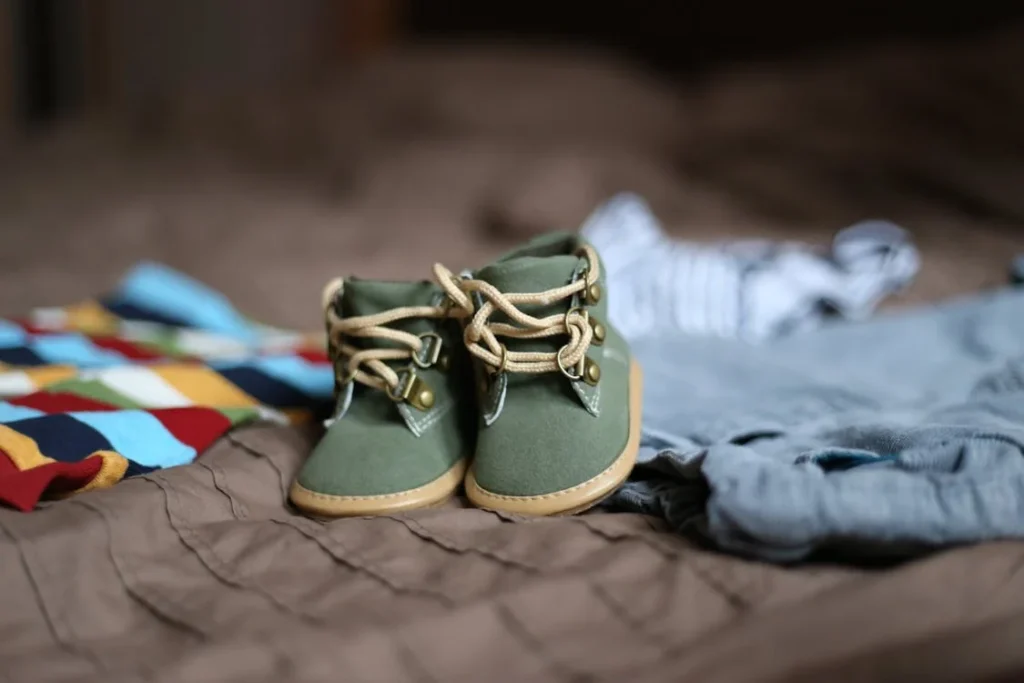 Baby's Green and Beige Sneakers on Brown Textile // Healthier Baby Today