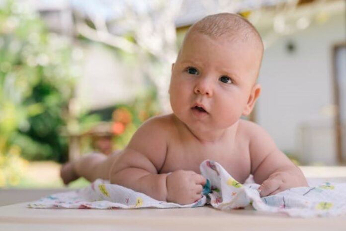 Close-Up Photo Of Baby on belly doing tummy time // Healthier Baby Today