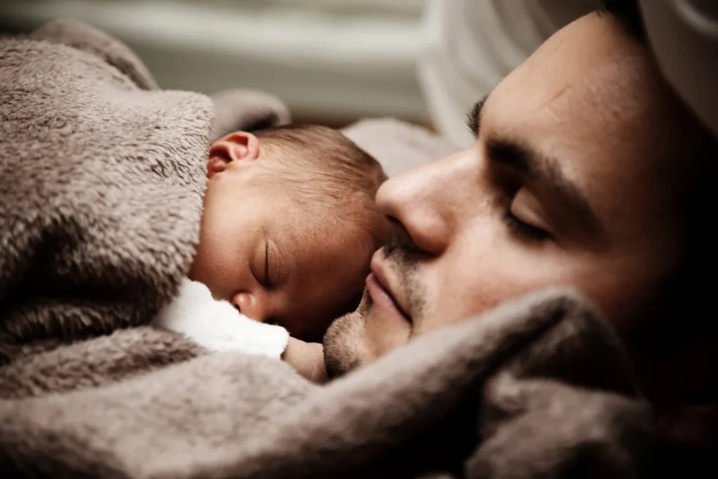 Close up of a Dad and his Little Baby Sleeping Together // Healthier Baby Today