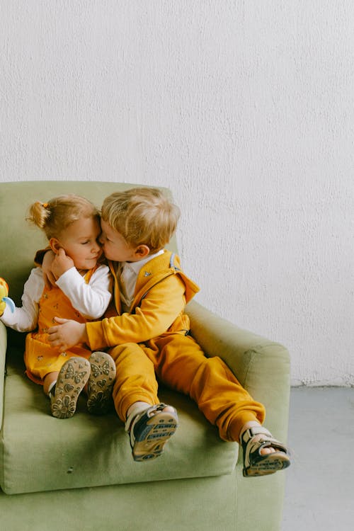Cute children cuddling in armchair at home // Healthier Baby Today