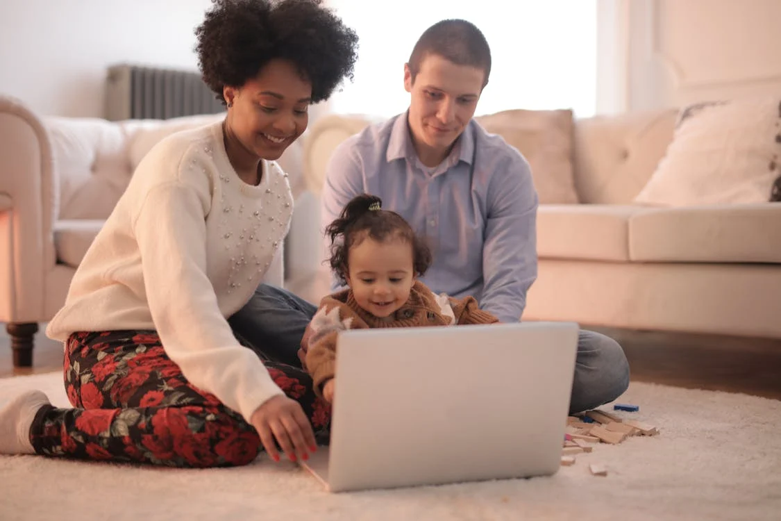 Photo of Family Sitting on Floor While Using Laptop // Healthier Baby Today