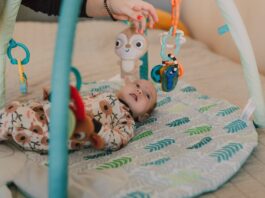 Baby Sensory Toys, A Cute Baby Lying Down while Looking at the Toys Hanging // Healthier Baby Today