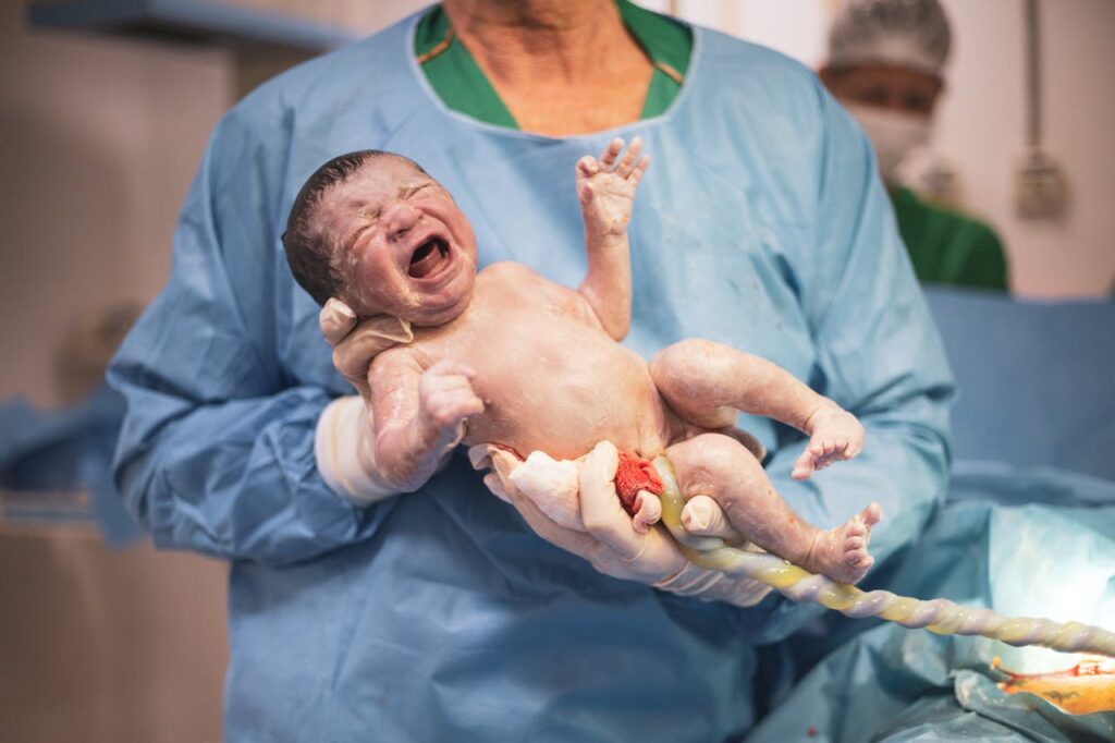 A Nurse Holding a Newborn Child // Healthier Baby Today