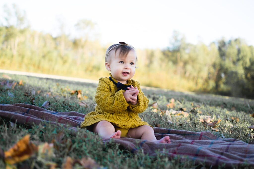 Baby Wearing Yellow Crochet Long Sleeve Dress Sitting on Brown Textile // Healthier Baby Today