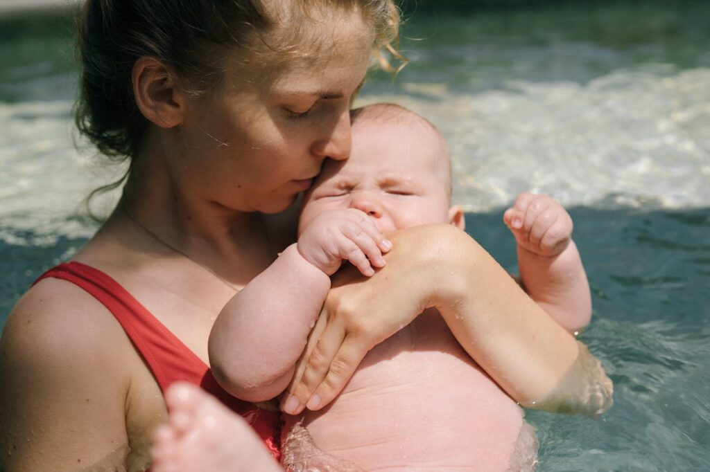 Close-Up Photo of Mother Carrying Her Baby in the Swimming Pool // Healthier Baby Today