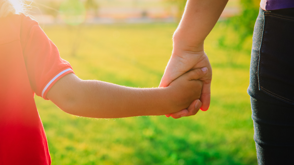 Kid and parent holding hands // Healthier Baby Today