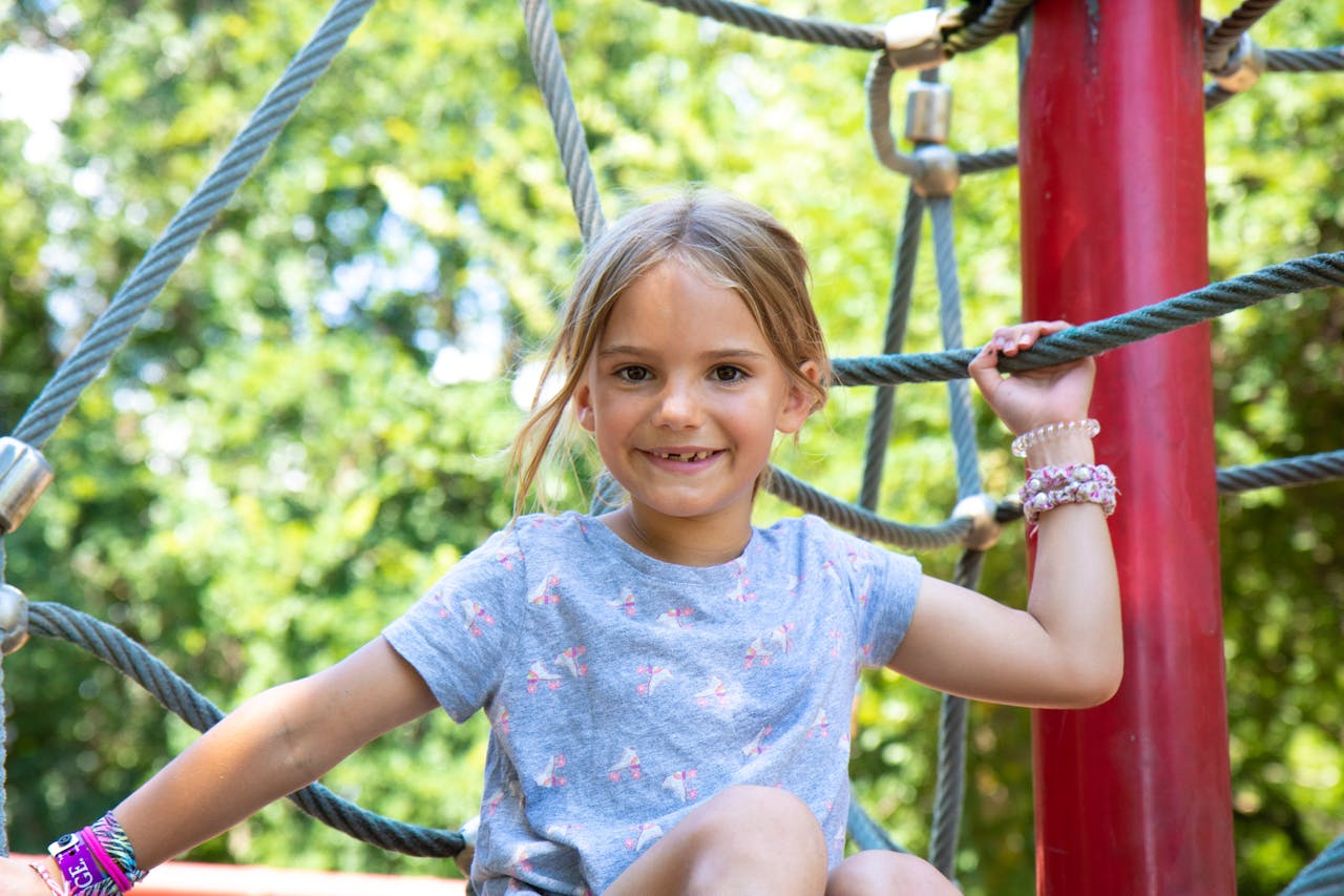 Girl Holding on the Ropes While Playing // Healthier Baby Today