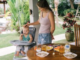 Baby Travel Essentials, Mother Looking at Her Cute Baby Sitting on a High Chair // Healthier Baby Today