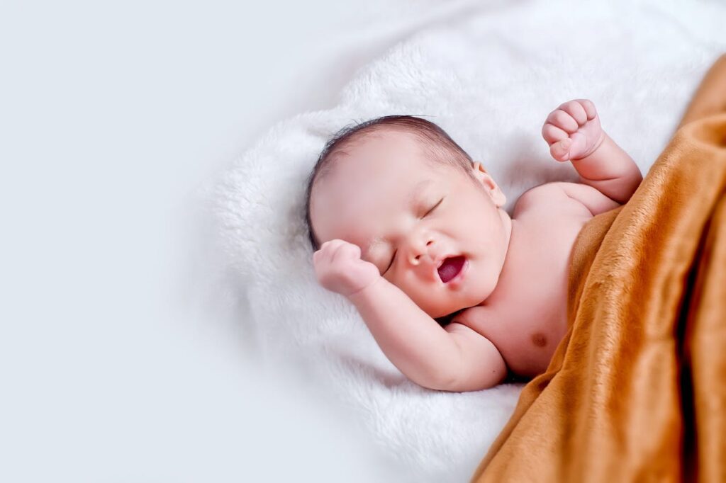 Baby Lying On White Fur With Brown Blanket // Healthier Baby Today