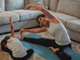 Gymnastic Home Equipment, Cheerful Asian mother and daughter stretching body in living room // Healthier Baby Today