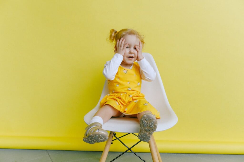 Girl In Yellow Dress Covering Her Face With Her Hands // Healthier Baby Today