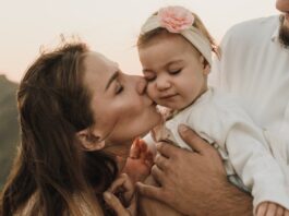 Gentle Parenting, Happy parents hugging and kissing baby // Healthier Baby Today