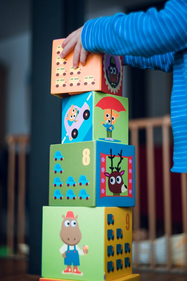 Person Holding Yellow and Pink Lego Blocks // Healthier Baby Today