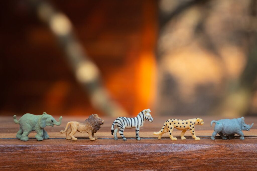 Plastic Animal Toys on Wooden Surface // Healthier Baby Today