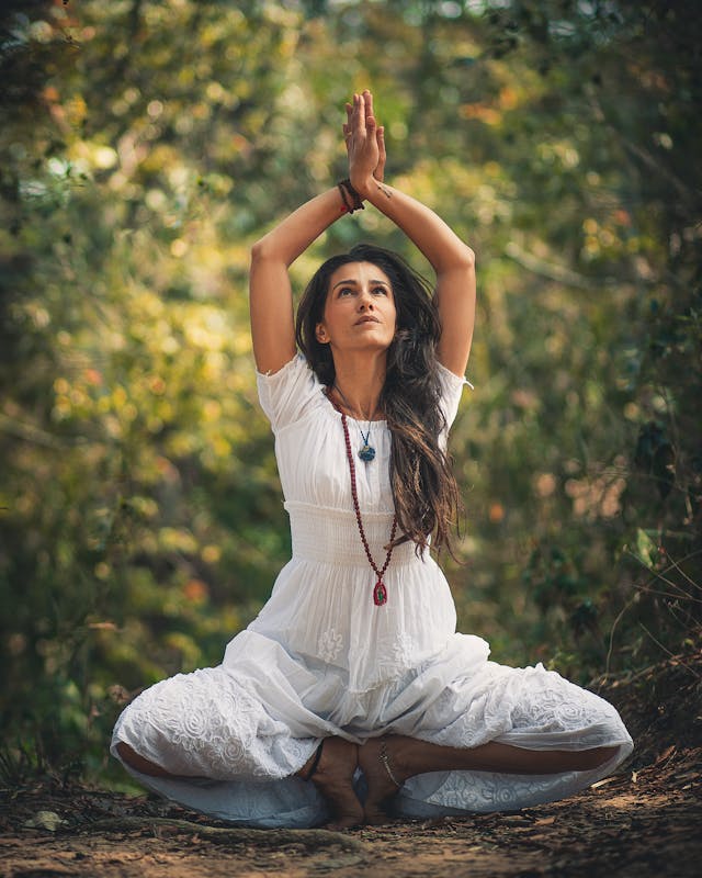 Woman Squatting on Ground While Raising Both Hands // Healthier Baby Today