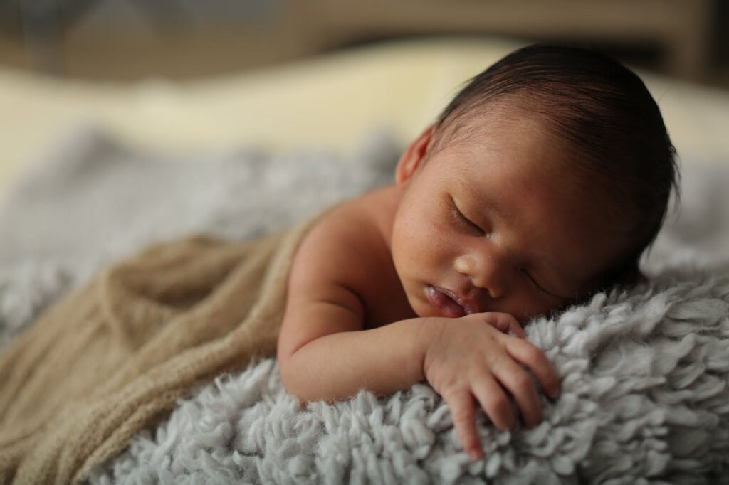 Baby Lying on Gray Fur Textile // Healthier Baby Today