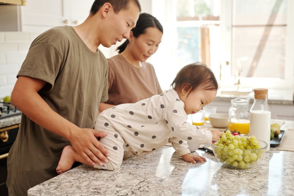 A Toddler Picking Fresh Grape in a Bowl // Healthier Baby Today