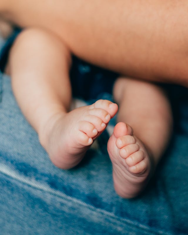 A baby's feet are shown in a close up // Healthier Baby Today