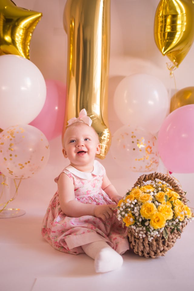 Baby Girl in Pink Dress Sitting on Floor with Basket of Flowers // Healthier Baby Today