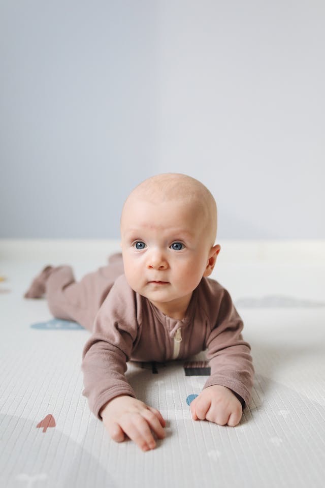 Photo of a baby lying on mat // Healthier Baby Today