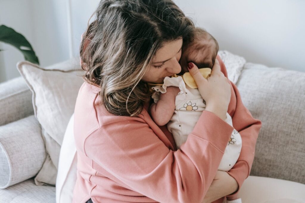 Mother holding her baby to her chest // Healthier Baby Today