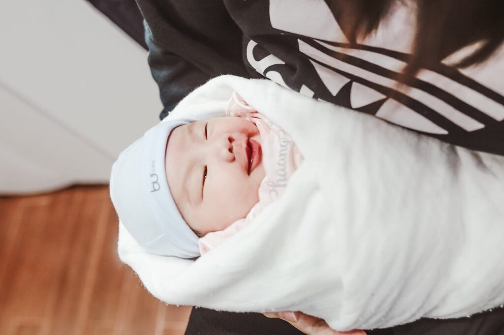 Baby wrapped up in a white blanket // Healthier Baby Today