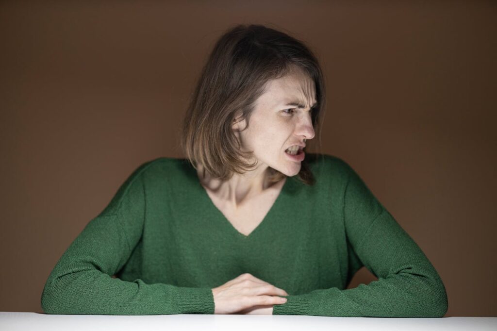 Woman in green sweater, extremely angry // Healthier Baby Today