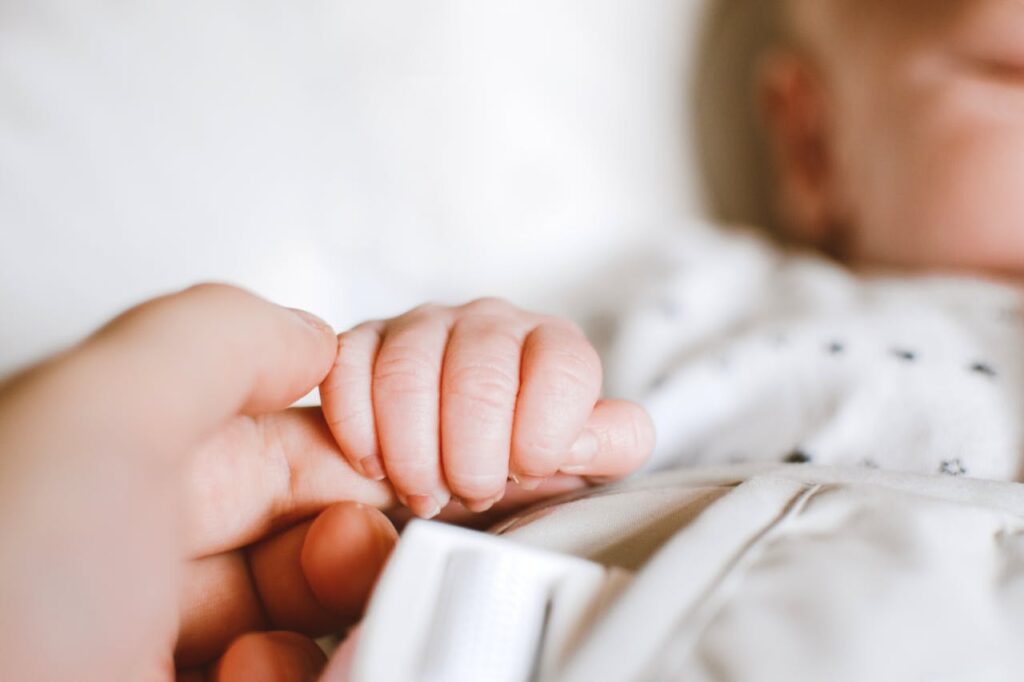 Person Holding Baby's Hand // Healthier Baby Today