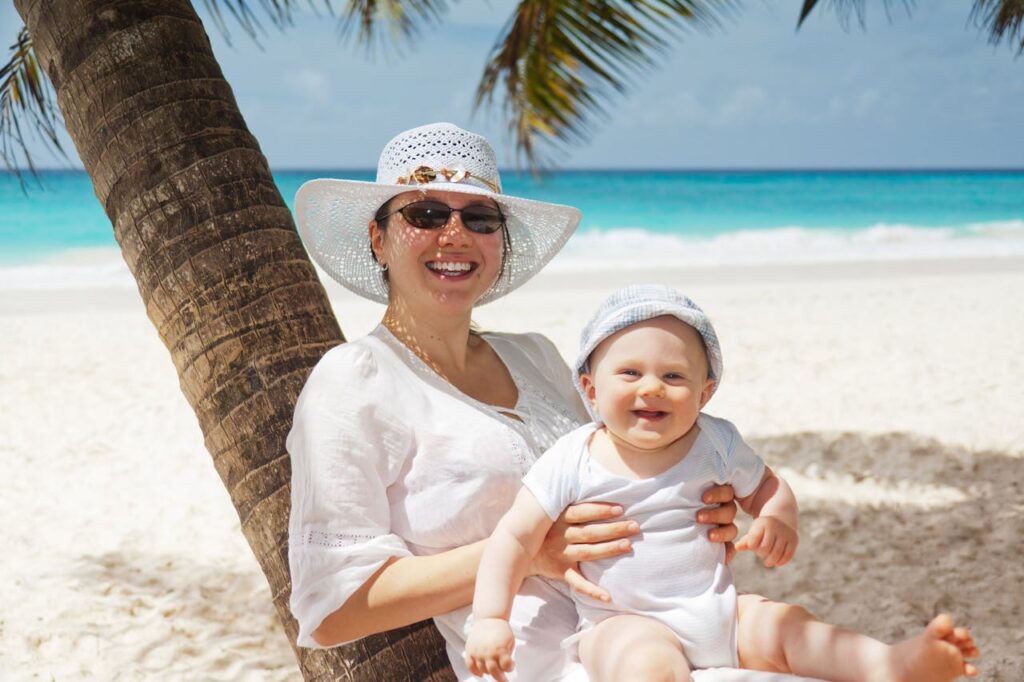 Woman Holding Infant on Beach // Healthier Baby Today