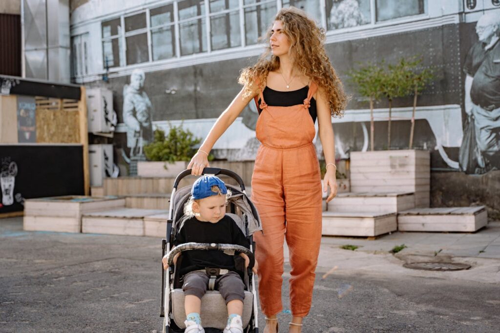 Woman in Dungarees with Child in a Pram // Healthier Baby Today